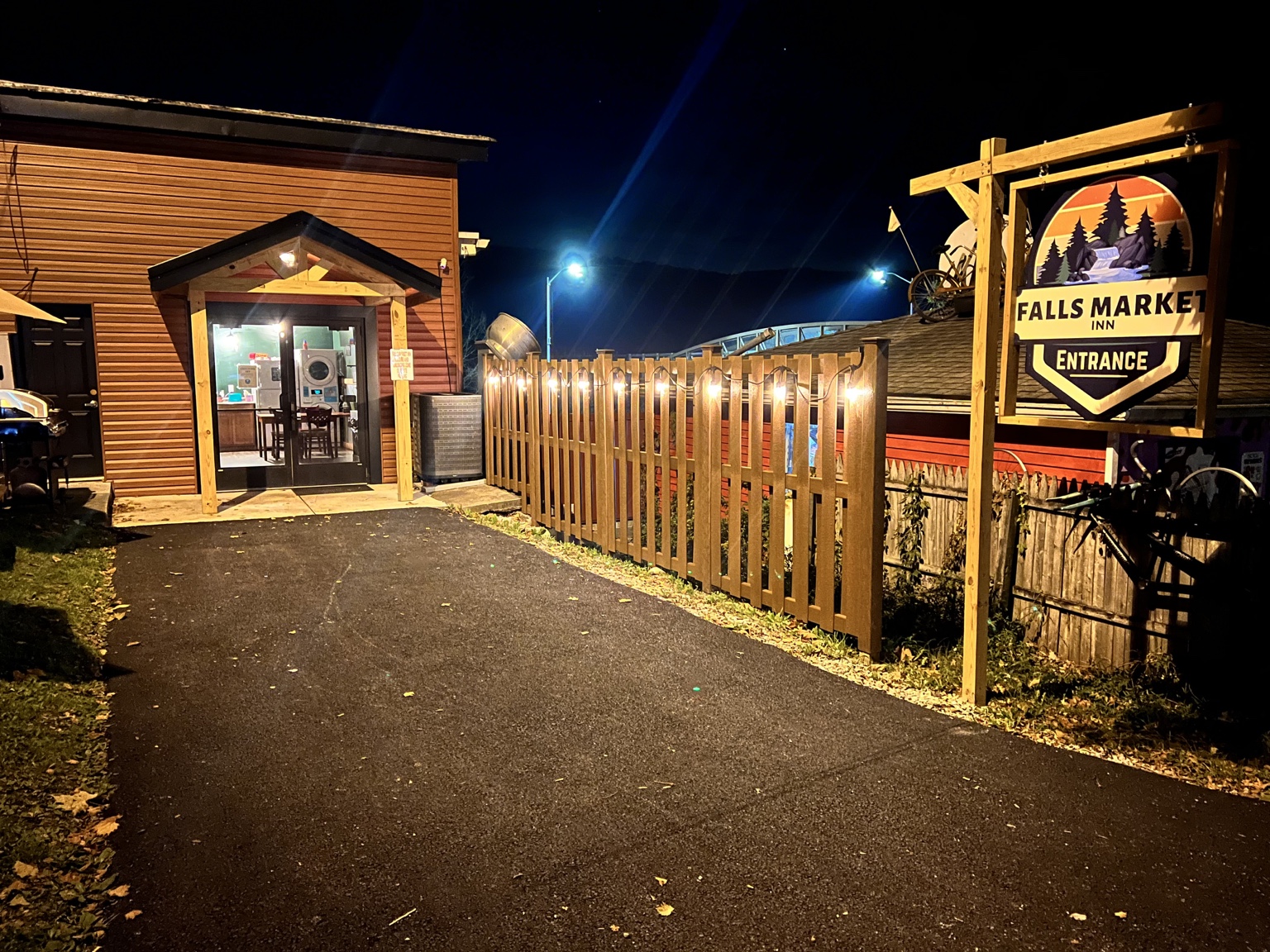 Illuminated Falls Market Inn entrance at night